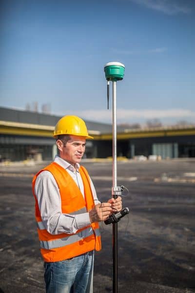 Surveyor using GPS equipment during an ALTA survey for a commercial property