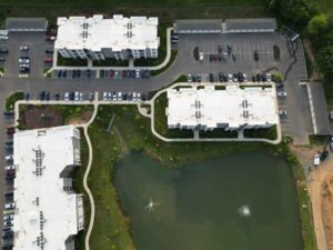 Aerial view of multiple properties and a shared stormwater pond in Prattville Alabama